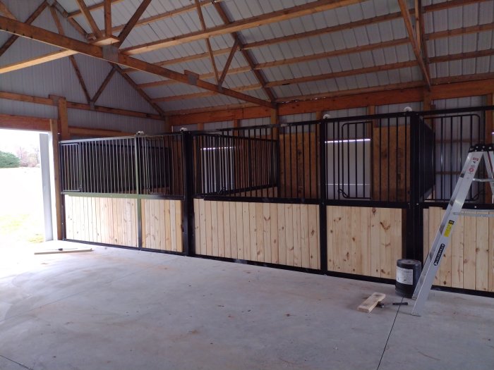 Modular horse stall panels being installed